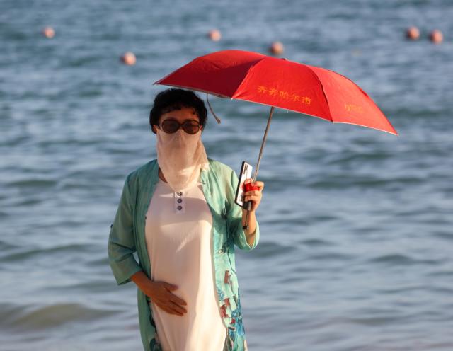 Защо китайките ходят на плаж напълно облечени?